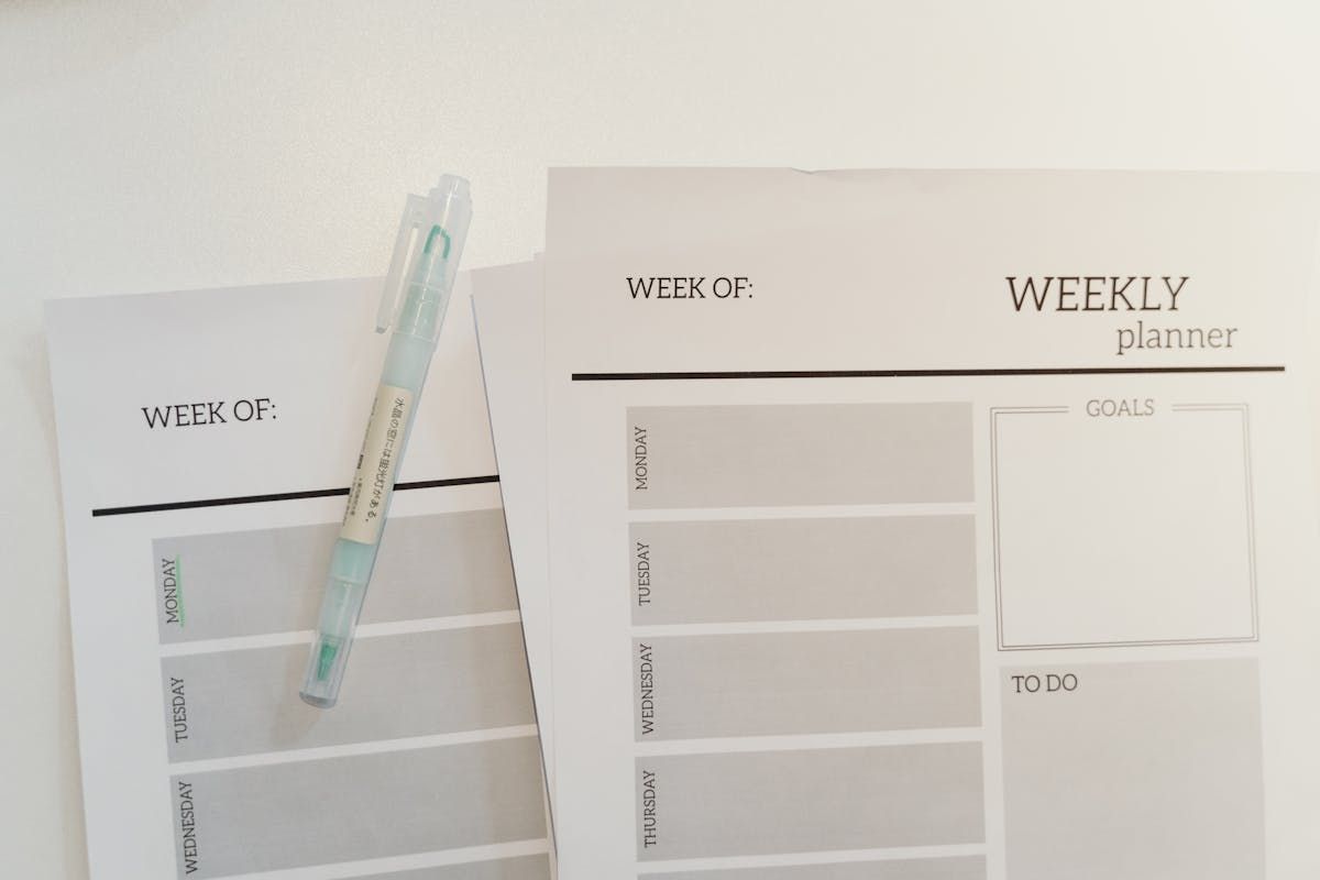 Weekly cleaning schedule planner with pen