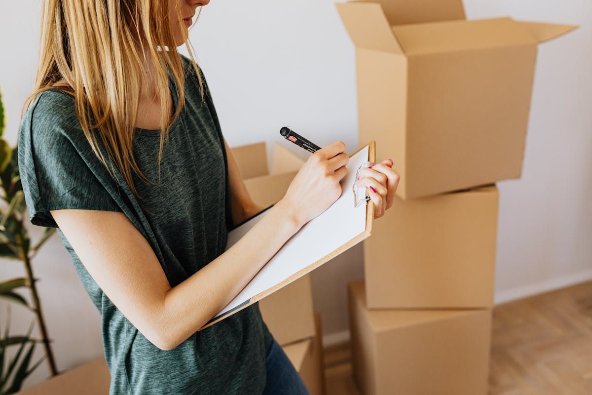 Woman with clipboard organizing and preparing before a professional cleaning visit