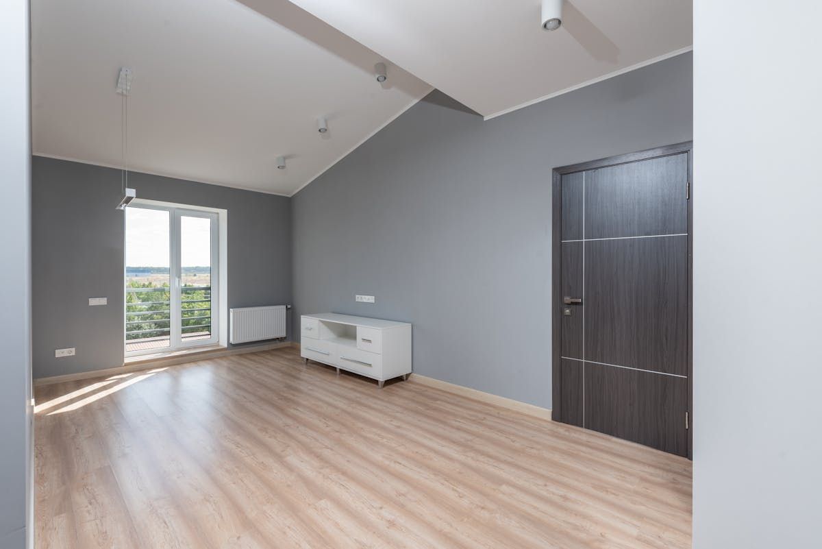 Spotless empty room with hardwood floors after professional move-out cleaning